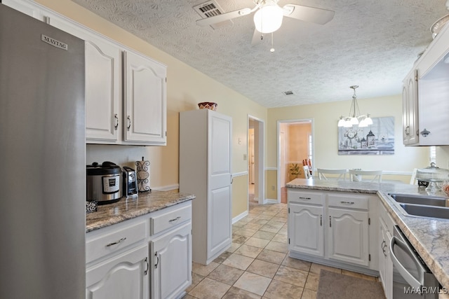 kitchen featuring ceiling fan with notable chandelier, sink, decorative light fixtures, white cabinetry, and stainless steel appliances