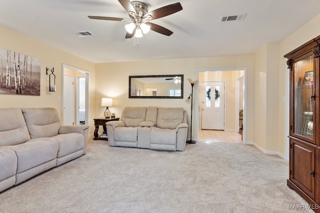 living room featuring light carpet and ceiling fan