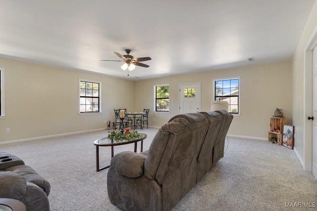 carpeted living room with ceiling fan