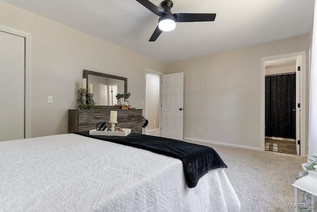 carpeted bedroom with ceiling fan and a textured ceiling