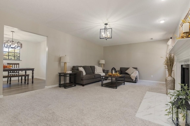 living room with carpet floors and a notable chandelier