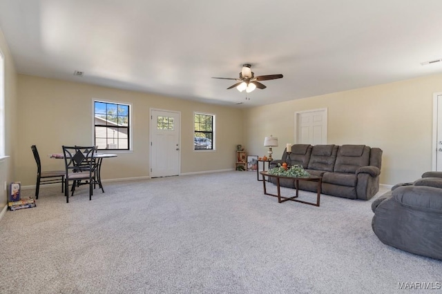 carpeted living room featuring ceiling fan