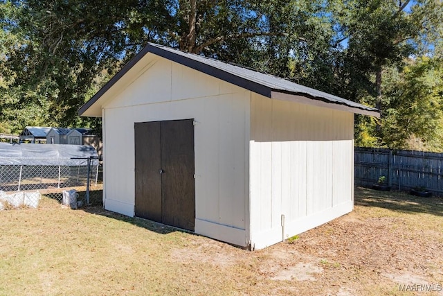 view of outdoor structure featuring a lawn