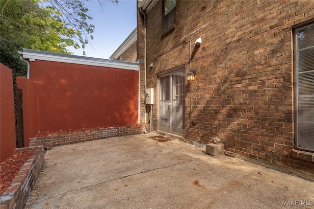 view of property exterior with a patio area