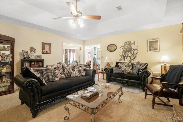 living room featuring light carpet and ceiling fan