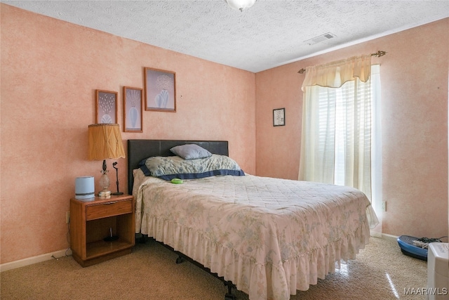 bedroom with light carpet and a textured ceiling