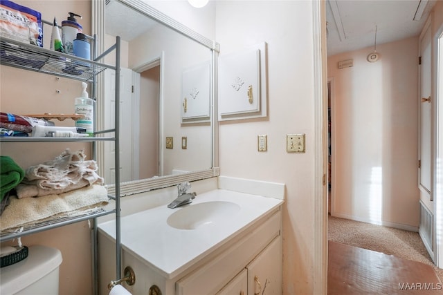 bathroom featuring vanity and toilet