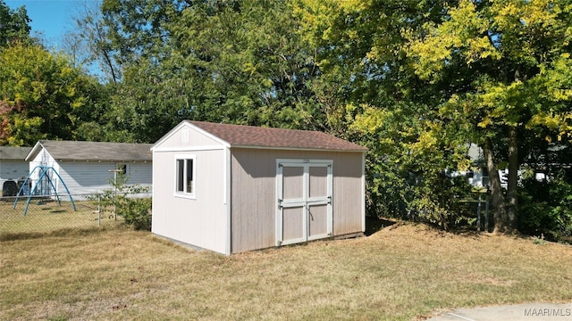 view of outbuilding featuring a lawn