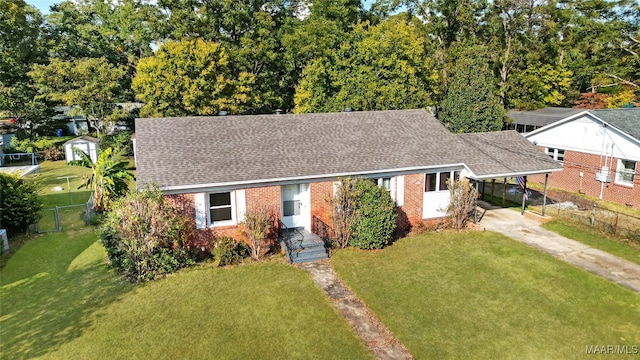 view of front of property with a carport and a front lawn