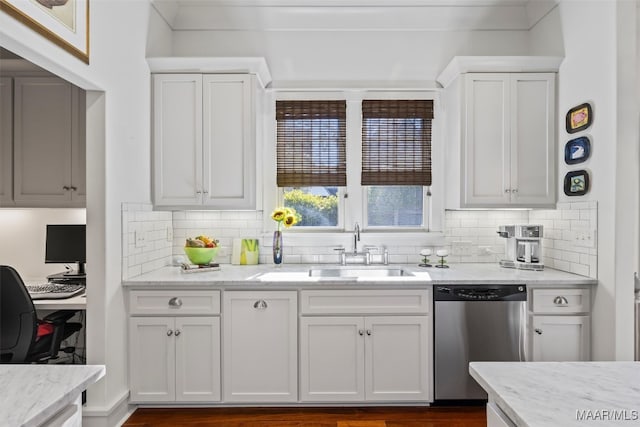 kitchen with stainless steel dishwasher, sink, and white cabinetry