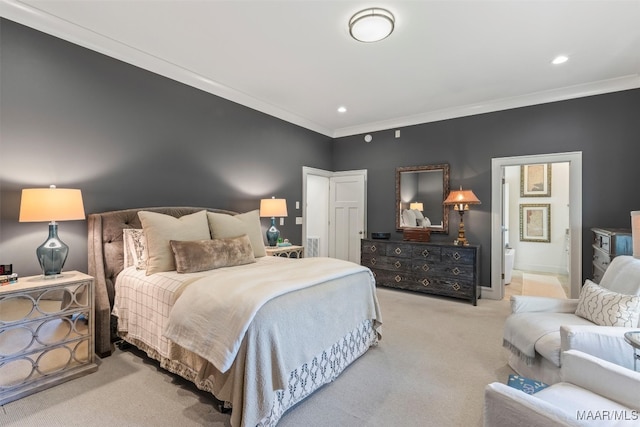 carpeted bedroom with crown molding and ensuite bath