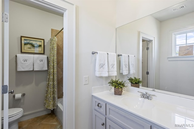 full bathroom with vanity, shower / tub combo, and toilet