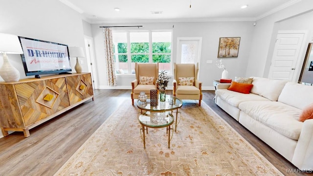 living room with wood-type flooring and crown molding