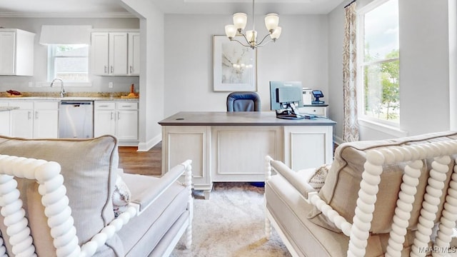 office space with an inviting chandelier, light hardwood / wood-style flooring, plenty of natural light, and sink