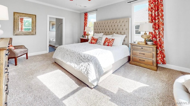 carpeted bedroom featuring multiple windows, ensuite bathroom, crown molding, and ceiling fan