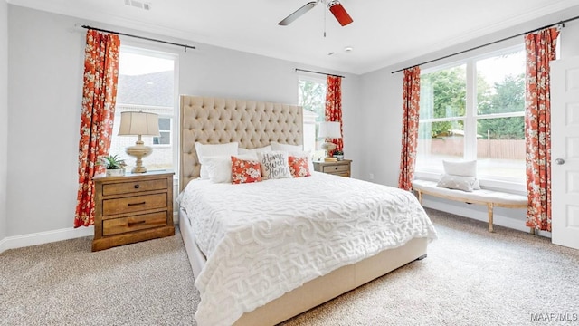 bedroom featuring light carpet, multiple windows, and ceiling fan