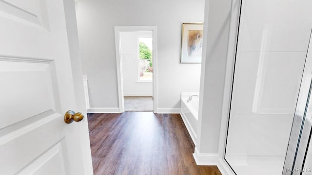 bathroom with independent shower and bath and hardwood / wood-style flooring