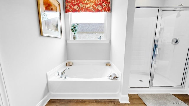 bathroom with separate shower and tub and wood-type flooring