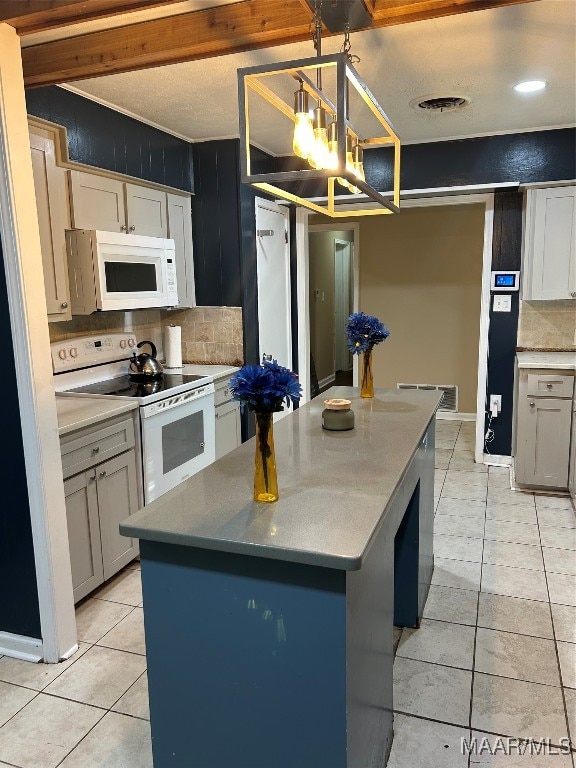 kitchen featuring white appliances, a center island, hanging light fixtures, decorative backsplash, and light tile patterned floors