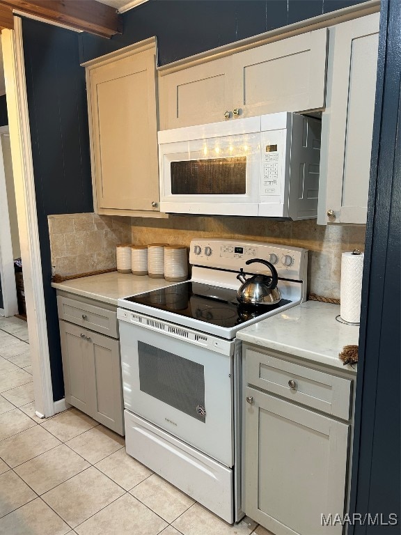 kitchen featuring backsplash, white appliances, and light tile patterned floors