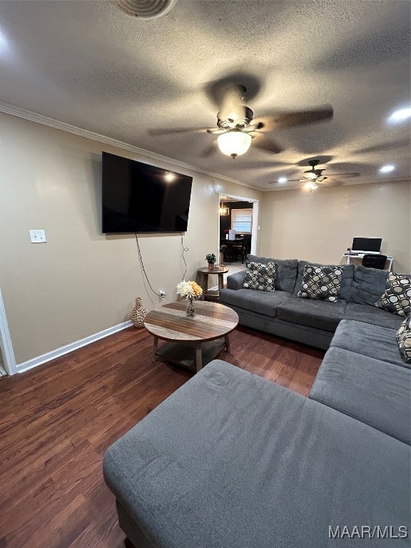 living room featuring ceiling fan, crown molding, a textured ceiling, and dark hardwood / wood-style floors