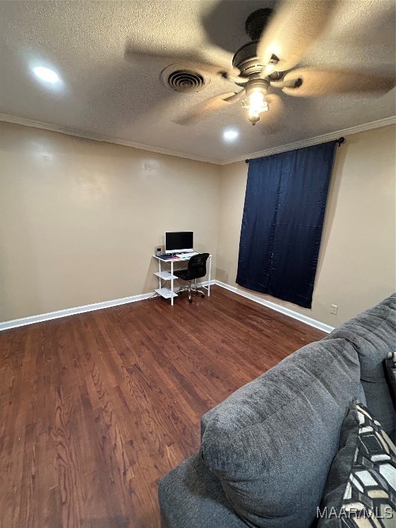 office space featuring ceiling fan, a textured ceiling, dark hardwood / wood-style flooring, and ornamental molding