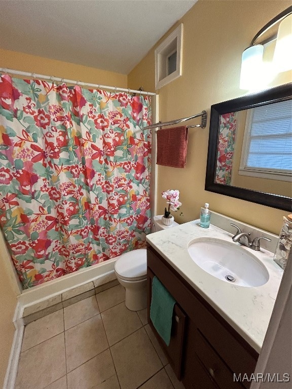 bathroom with vanity, toilet, tile patterned floors, and a shower with shower curtain