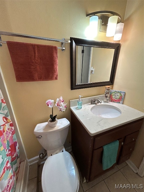 bathroom featuring vanity, toilet, and tile patterned floors