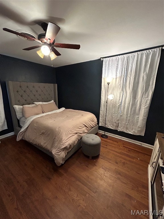 bedroom featuring dark wood-type flooring and ceiling fan