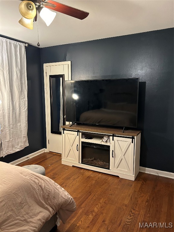 bedroom with hardwood / wood-style floors and ceiling fan