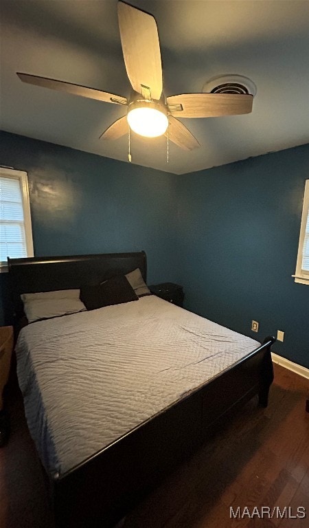 bedroom with ceiling fan and wood-type flooring