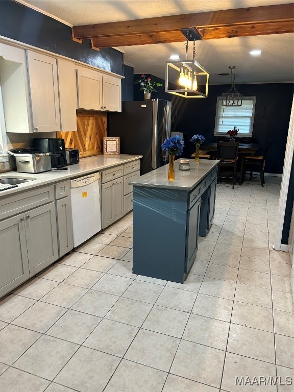 kitchen with white dishwasher, a center island, beam ceiling, stainless steel refrigerator, and light tile patterned floors