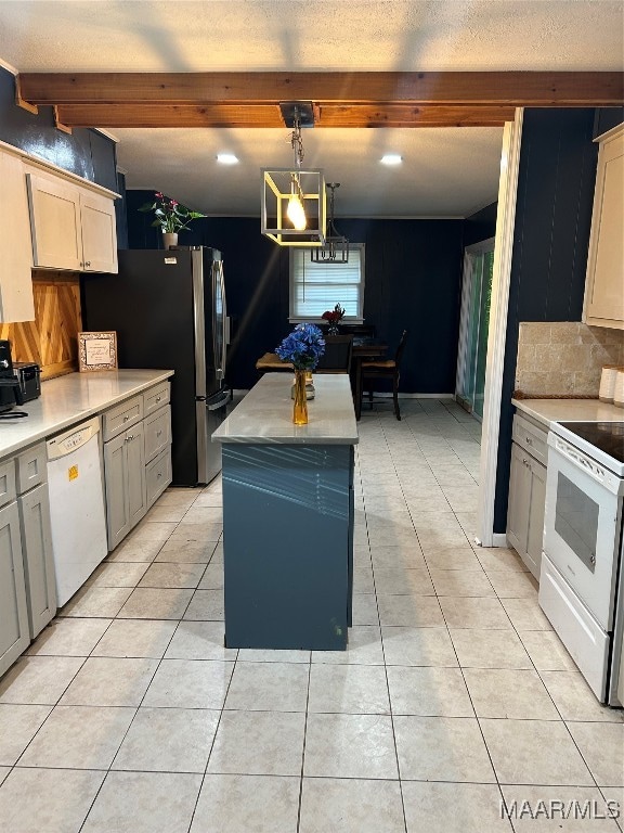 kitchen with beam ceiling, hanging light fixtures, a center island, light tile patterned flooring, and white appliances