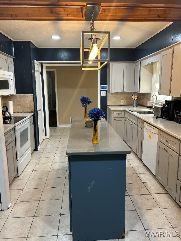 kitchen featuring white appliances, tasteful backsplash, a center island, and hanging light fixtures