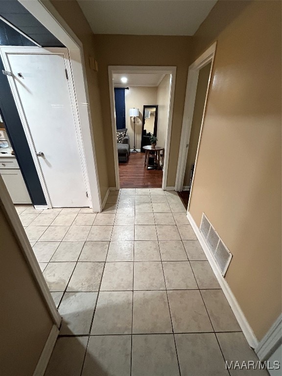 hall featuring light tile patterned floors