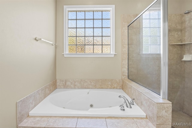 bathroom featuring shower with separate bathtub and a healthy amount of sunlight