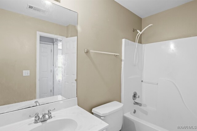 full bathroom with vanity, washtub / shower combination, and toilet