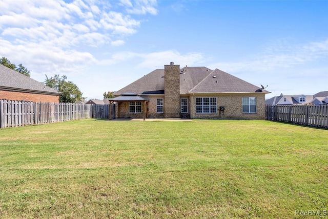 rear view of property with a patio area and a lawn