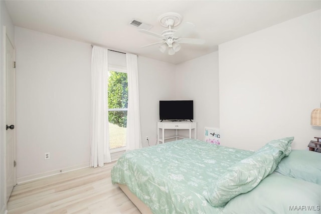 bedroom with ceiling fan and light hardwood / wood-style flooring