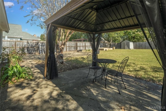 view of patio featuring a gazebo and a storage shed