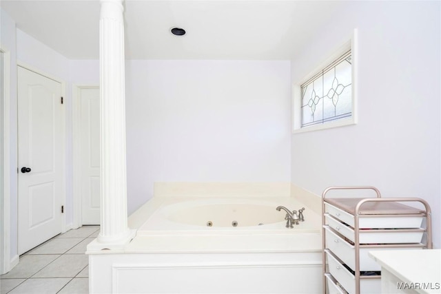 bathroom with vanity, a bathtub, tile patterned floors, and decorative columns