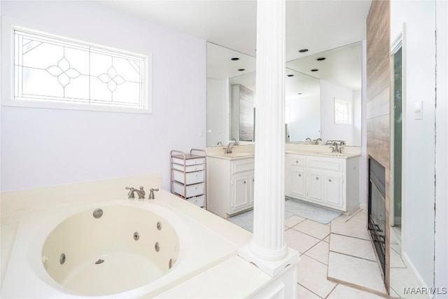 bathroom featuring vanity, a washtub, tile patterned flooring, and ornate columns