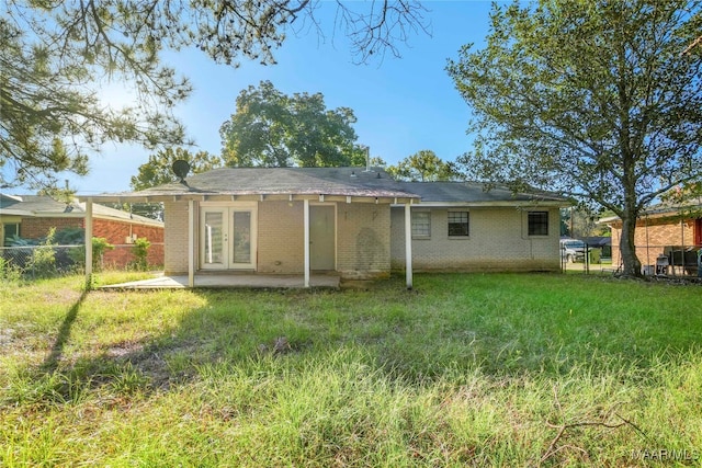 back of house featuring a yard and a patio area