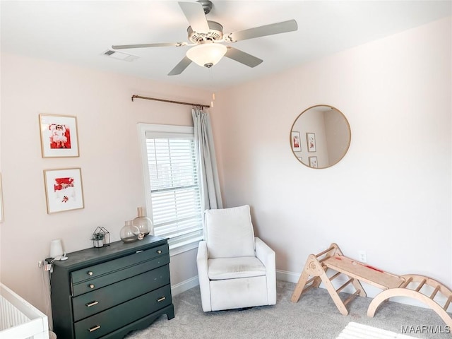 sitting room featuring light carpet and ceiling fan