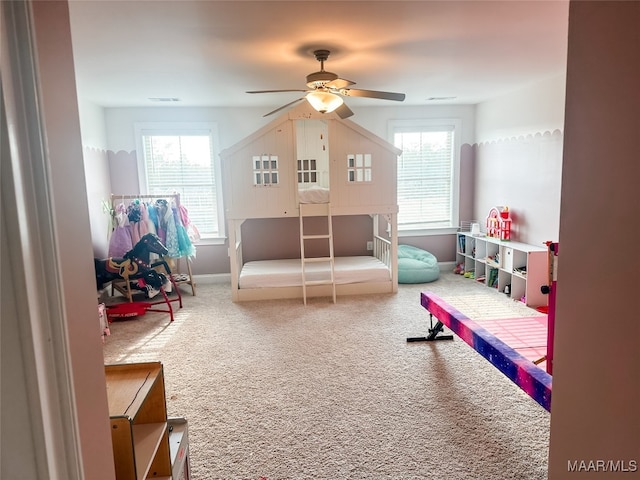 rec room with a wealth of natural light, carpet floors, and ceiling fan