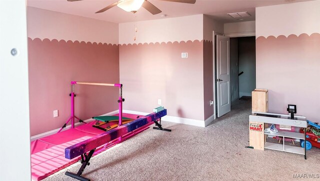 interior space with ceiling fan and carpet