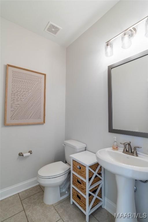 bathroom featuring tile patterned flooring, sink, and toilet