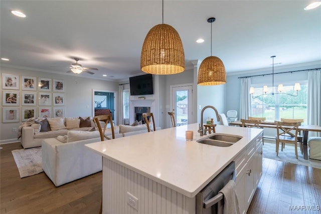 kitchen featuring white cabinetry, sink, stainless steel dishwasher, and a center island with sink