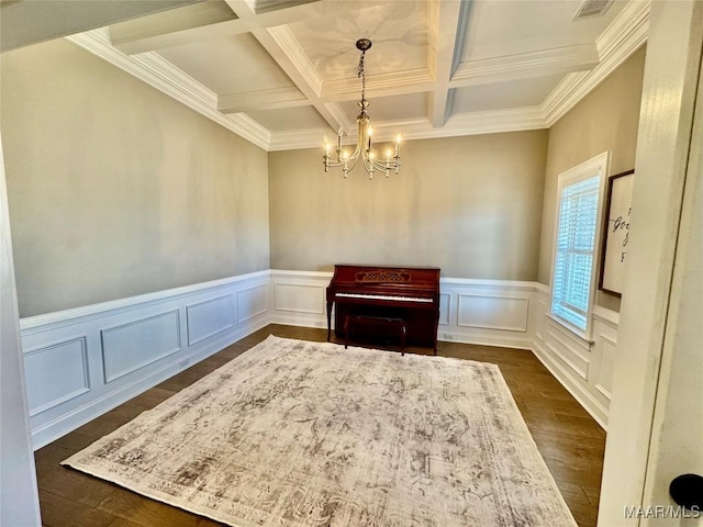 miscellaneous room featuring coffered ceiling, a notable chandelier, dark wood-type flooring, and beamed ceiling