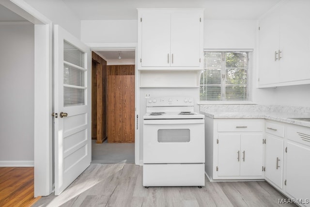 kitchen with light hardwood / wood-style floors, white cabinetry, and electric stove